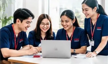 CSM Academy students collaborating around a laptop